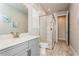 Bright bathroom featuring marble floors, a glass shower stall and a white marble vanity at 20660 Ovid Ln, Venice, FL 34293