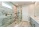 Bright bathroom featuring a large glass shower and a light marble vanity at 20660 Ovid Ln, Venice, FL 34293
