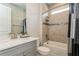 Bright bathroom featuring a tiled shower and tub combination and a vanity with marble countertop at 20660 Ovid Ln, Venice, FL 34293