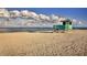 Scenic view of a lifeguard station on a sandy beach with the ocean and cloudy sky as a picturesque backdrop at 20660 Ovid Ln, Venice, FL 34293