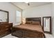 Comfortable bedroom featuring a large wooden bed and matching dresser with vanity mirror at 20660 Ovid Ln, Venice, FL 34293