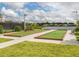 Scenic bocce ball courts overlooking a peaceful lake and lush green landscape on a sunny day at 20660 Ovid Ln, Venice, FL 34293