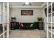 Spacious bonus room features arcade games, a lounge area, and contemporary design at 20660 Ovid Ln, Venice, FL 34293