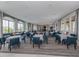 Community dining space with tables and chairs, with large windows offering lots of natural light at 20660 Ovid Ln, Venice, FL 34293
