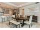 Open-concept dining room featuring modern lighting and a large wooden table next to the kitchen at 20660 Ovid Ln, Venice, FL 34293