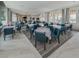 Large dining room with tables, chairs, and elegant decor providing an inviting space for community gatherings at 20660 Ovid Ln, Venice, FL 34293