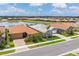A residential street showcases well-maintained homes with lovely landscaping and a peaceful lake backdrop at 20660 Ovid Ln, Venice, FL 34293