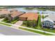 Beautiful single-Gathering home with a tile roof, lush landscaping, and a lake view in a well-maintained community at 20660 Ovid Ln, Venice, FL 34293