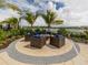 Cozy outdoor firepit area with comfortable seating and scenic lake views, perfect for gatherings at 20660 Ovid Ln, Venice, FL 34293