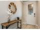 Entryway with a decorative mirror, wooden table, and tiled flooring at 20660 Ovid Ln, Venice, FL 34293