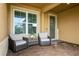 Cozy front porch with comfortable seating and a welcoming entrance at 20660 Ovid Ln, Venice, FL 34293
