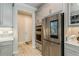 Kitchen with stainless steel refrigerator, built-in oven, and gray cabinets providing ample storage space at 20660 Ovid Ln, Venice, FL 34293
