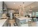 Open concept kitchen with stainless steel appliances, a large island with bar seating, and access to the dining area at 20660 Ovid Ln, Venice, FL 34293