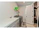 Laundry room with sink, washer, shelving and bright white paint at 20660 Ovid Ln, Venice, FL 34293