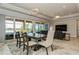 Bright living room featuring large sliding glass doors leading to an outdoor living space with a pool at 20660 Ovid Ln, Venice, FL 34293