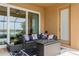 Inviting outdoor patio space featuring modern wicker seating, a cozy fire pit, and tranquil lake views at 20660 Ovid Ln, Venice, FL 34293