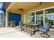 An outdoor patio showcasing a dining table with seating and a stainless steel grill for entertaining at 20660 Ovid Ln, Venice, FL 34293