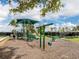 Lush green community playground featuring a shade structure, swings, and slides for children to enjoy at 20660 Ovid Ln, Venice, FL 34293