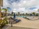 Resort-style pool area featuring lounge chairs, palm trees, and a serene swimming environment at 20660 Ovid Ln, Venice, FL 34293