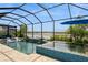 Stunning pool area with a spa and lake view under a screened enclosure with outdoor seating at 20660 Ovid Ln, Venice, FL 34293