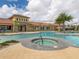 Beautiful community pool area with lush landscaping, a hot tub, and plenty of seating for residents at 20660 Ovid Ln, Venice, FL 34293