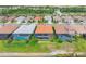 A view of multiple backyard pools and screen-enclosed lanais facing a serene lake at 20660 Ovid Ln, Venice, FL 34293