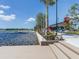Picturesque waterfront view featuring a community dock, lake access, and lush landscaping, perfect for outdoor enjoyment at 20660 Ovid Ln, Venice, FL 34293