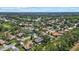 Residential aerial view of community featuring a pond, lush landscaping, and attractive homes at 2092 Timucua Trl, Nokomis, FL 34275