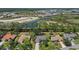 Panoramic aerial view showcases the residential community, a serene pond, and the surrounding natural landscape at 2092 Timucua Trl, Nokomis, FL 34275