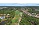 Beautiful community aerial with golf course, lake, and well-maintained homes amidst lush greenery at 2092 Timucua Trl, Nokomis, FL 34275