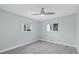 A cozy bedroom features two windows, light wood floors, and neutral walls, creating a serene and inviting space at 2092 Timucua Trl, Nokomis, FL 34275