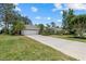 Well-kept single-story home with a long driveway, two-car garage, and verdant lawn in a tranquil neighborhood at 2092 Timucua Trl, Nokomis, FL 34275