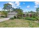 Inviting single-story home showcasing mature landscaping, a tiled roof, and a spacious two-car garage at 2092 Timucua Trl, Nokomis, FL 34275