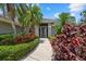 Landscaped front entrance featuring a walkway leading to the front door, framed by colorful plants at 2092 Timucua Trl, Nokomis, FL 34275