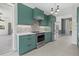 Modern kitchen featuring sleek cabinets, stainless steel appliances and neutral backsplash at 2092 Timucua Trl, Nokomis, FL 34275