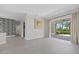 Bright living area featuring patterned wallpaper, neutral paint, recessed lighting, and patio access at 2092 Timucua Trl, Nokomis, FL 34275