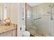 Updated bathroom showcases a tiled shower with glass door and modern fixtures for a spa-like experience at 2311 Sandlewood Dr, Venice, FL 34293