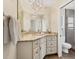 Tastefully updated bathroom featuring a granite countertop, custom vanity, and modern lighting fixtures at 2311 Sandlewood Dr, Venice, FL 34293