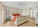 Relaxing bedroom with neutral tones, wood floors, and ample natural light from the large windows at 2311 Sandlewood Dr, Venice, FL 34293