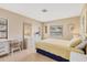 Bright bedroom with white wood furnishings, warm yellow bedding, and plenty of natural light at 2311 Sandlewood Dr, Venice, FL 34293