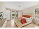 Comfortable bedroom with sliding glass doors to the backyard and a dresser for additional storage at 2311 Sandlewood Dr, Venice, FL 34293