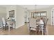 Dining area with wood floors, designer chandelier and views of the outside at 2311 Sandlewood Dr, Venice, FL 34293