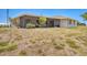 Back of the house with a screened lanai, surrounded by a large grassy area at 2311 Sandlewood Dr, Venice, FL 34293