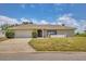 Charming single-story home with well-maintained lawn, a two car garage, and inviting curb appeal at 2311 Sandlewood Dr, Venice, FL 34293