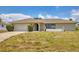 Charming single-story home featuring a well-manicured lawn and an attached two-car garage at 2311 Sandlewood Dr, Venice, FL 34293