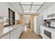 Well-lit kitchen with white appliances, ample counter space, and an open view into the dining area at 2311 Sandlewood Dr, Venice, FL 34293