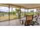 Lanai with chairs overlooking a serene waterfront view, perfect for relaxation and enjoying nature at 2311 Sandlewood Dr, Venice, FL 34293