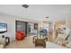 Spacious living room with sliding glass doors to the patio and seamless flow to the dining area at 2311 Sandlewood Dr, Venice, FL 34293