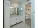 Bathroom featuring double sinks with tiled floors and walk-in shower at 232 Cerromar Way # 38, Venice, FL 34293