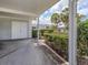 Carport with white double doors and lush landscaping at 232 Cerromar Way # 38, Venice, FL 34293